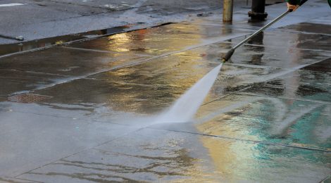high-pressure-cleaning-driveway-water-splashing-asphalt-washes-pavement-scaled.jpg